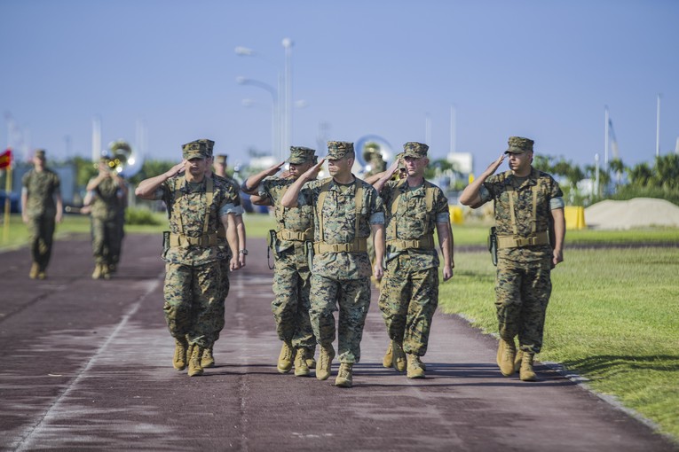 A group of Marines salute.